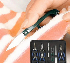 Knife being used on salmon with a set of pliers and tools in the foreground.