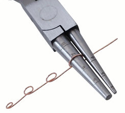 Metal tool with two cylindrical components and a copper wire on a white background
