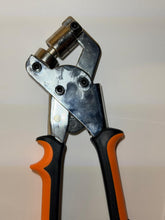Pvc cutting tool with black and orange handles on a white background