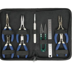 Set of jewelry-making tools including pliers and a ruler in a black case.