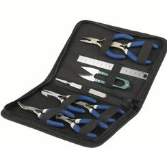 Set of pliers and tools in a black case on a white background