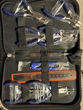 Set of pliers and tools in a black case with clear plastic bags.