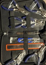 Set of pliers and tools in a black case with clear plastic covers.